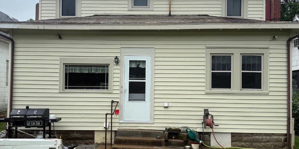 Same house siding after soft-wash, clean and bright