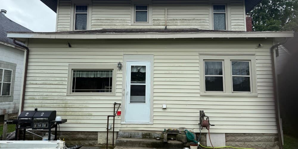 House siding before soft-wash, showing mildew and dirt streaks
