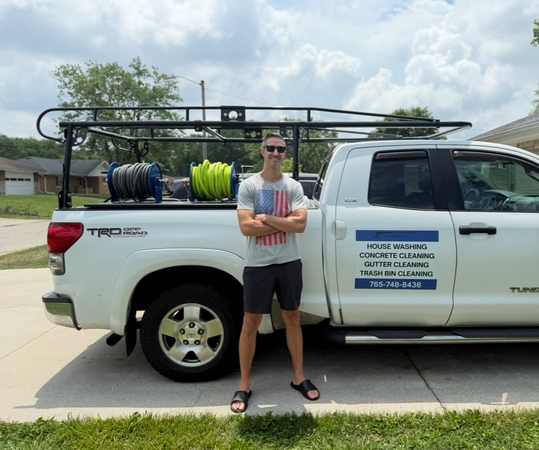 Owner of Exterior Express standing in front of the work truck in Muncie, Indiana
